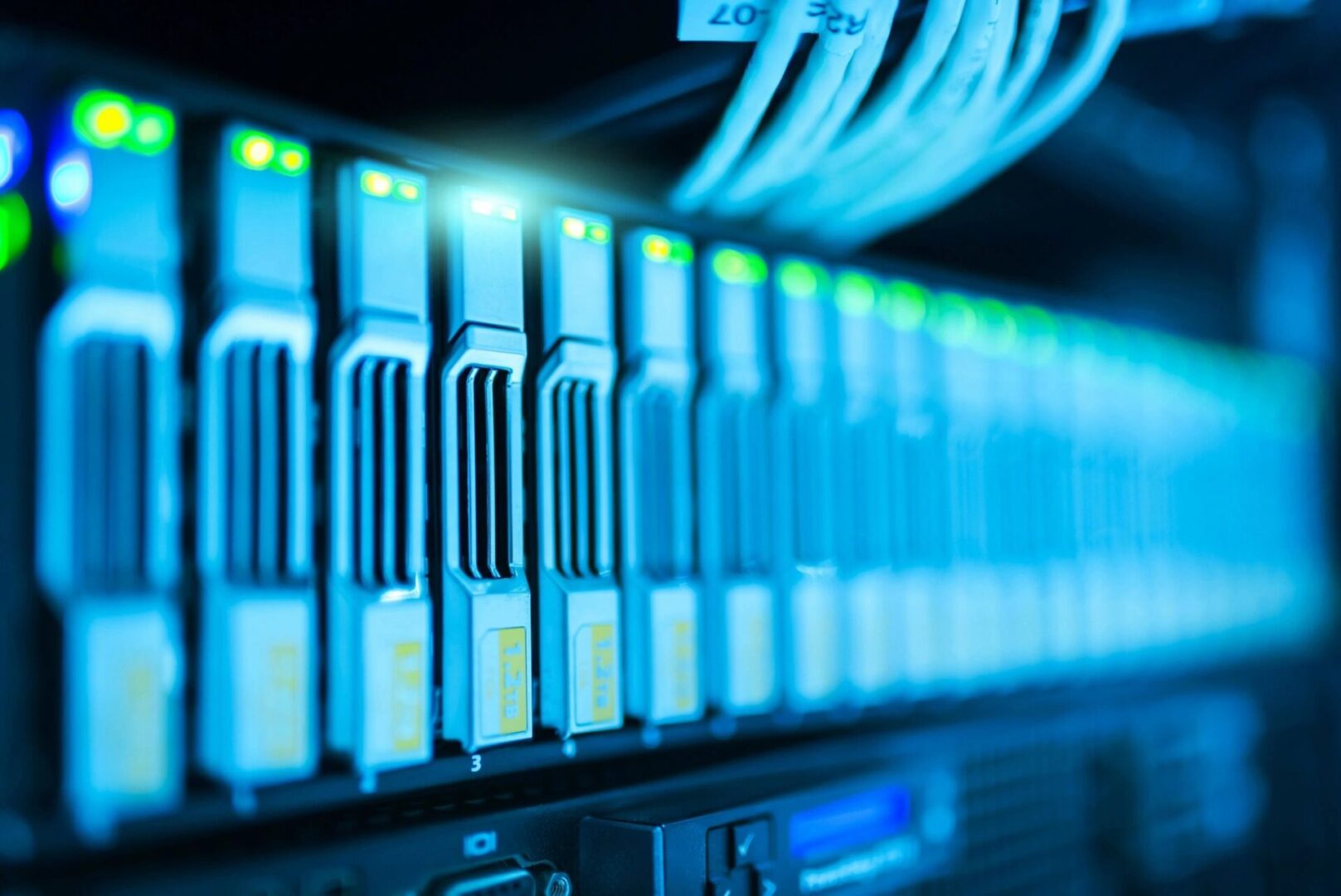 Close-up of network server cables connected to a data center rack.